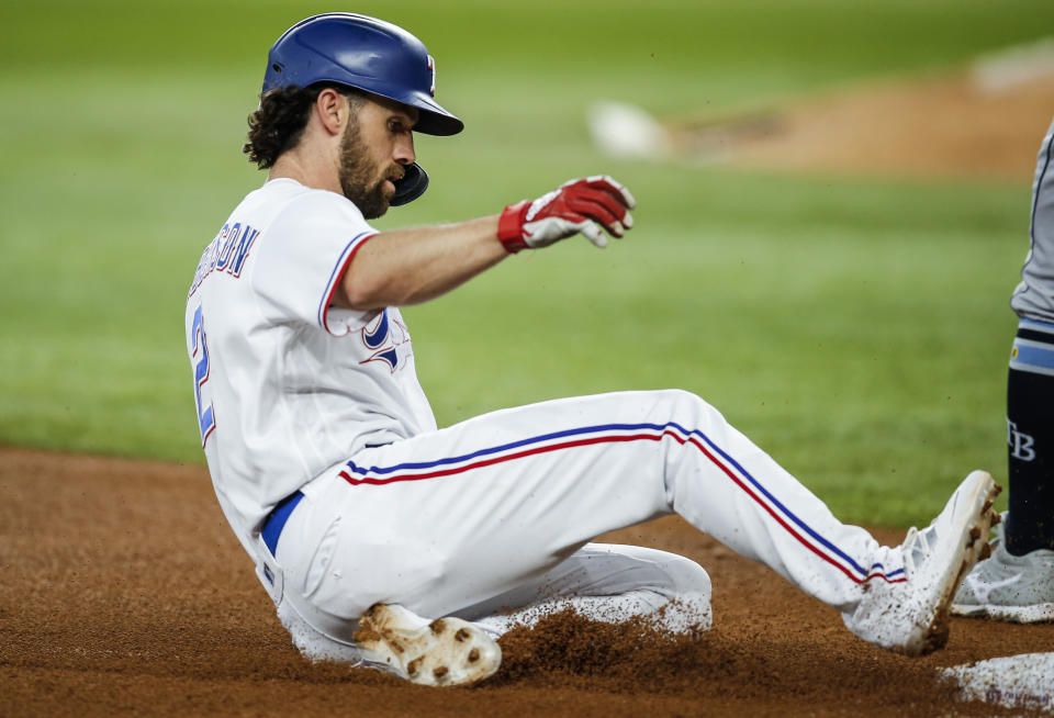 Texas Rangers' Charlie Culberson slides into third on a triple during the fifth inning of a baseball game against the Tampa Bay Rays, Saturday, June 5, 2021, in Arlington, Texas. (AP Photo/Brandon Wade)
