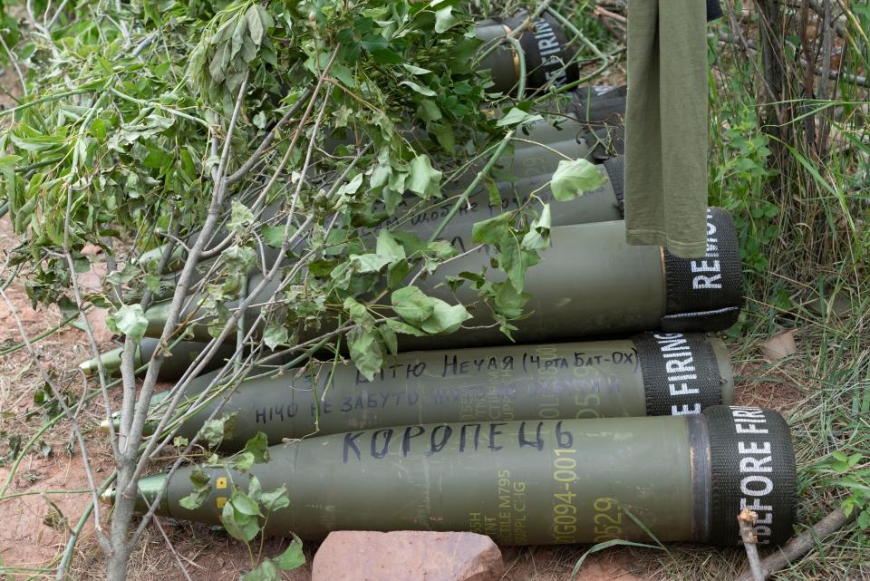 U.S.-supplied M777 howitzer shells lie on the ground to fire at Russian positions in Ukraine's eastern Donbas region June 18, 2022. Writing on one of them reads: "Nothing is forgotten". U.S. officials will send another $450 million in military aid to Ukraine.