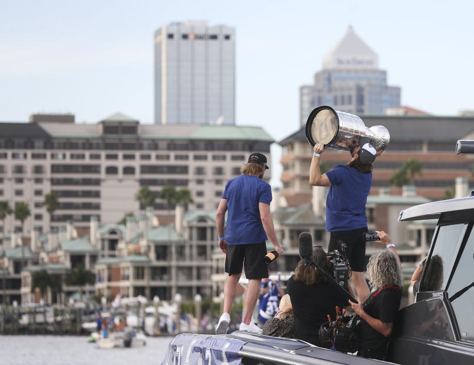 Tampa Bay Lightning' Steven Stamkos, left, stands on a boat as Victor Hedman hoists the Stanley Cup during the NHL hockey Stanley Cup champions' boat parade, Wednesday, Sept. 30, 2020, in Tampa, Fla. (Dirk Shadd/Tampa Bay Times via AP)