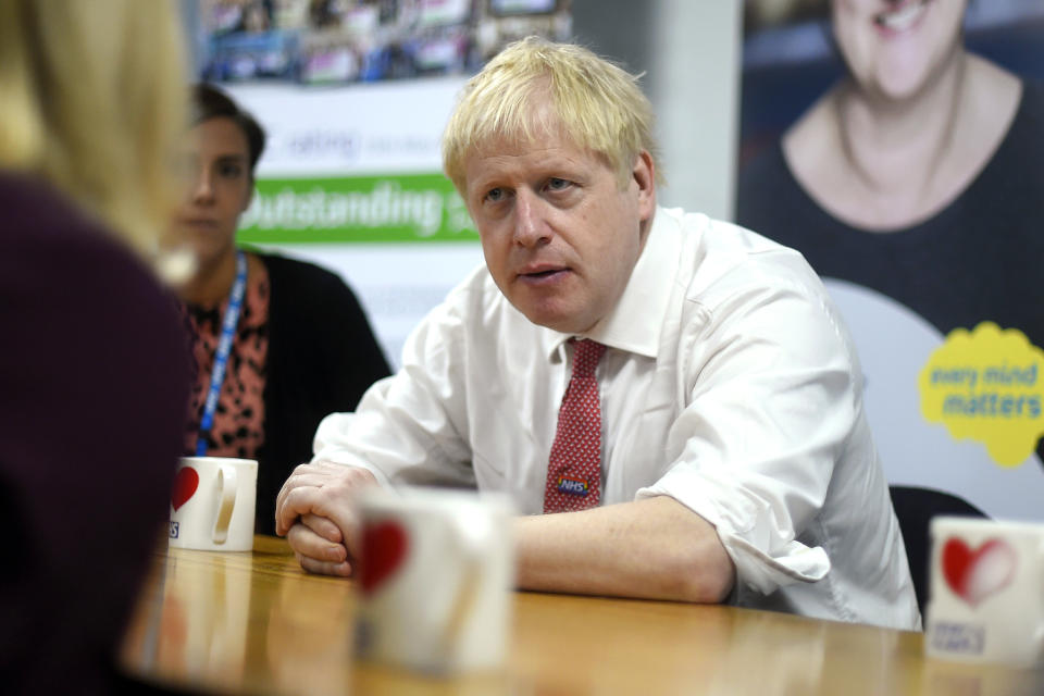 Britain's Prime Minister Boris Johnson speaks to mental health professionals during his visit to Watford General Hospital, in Watford, Monday, Oct. 7, 2019. Britain and the European Union appeared to be poles apart Monday on a potential Brexit deal, with the Dutch government urging the British government to offer "more realism and clarity," and U.K. Prime Minister Boris Johnson insisting the bloc has to soften its stance. (Peter Summers/Pool Photo via AP)