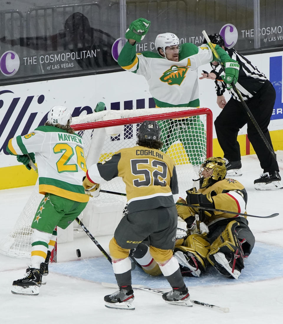 Minnesota Wild left wing Marcus Foligno, top right, celebrates after scoring against Vegas Golden Knights goaltender Marc-Andre Fleury (29) during the second period of an NHL hockey game Wednesday, March 3, 2021, in Las Vegas. (AP Photo/John Locher)