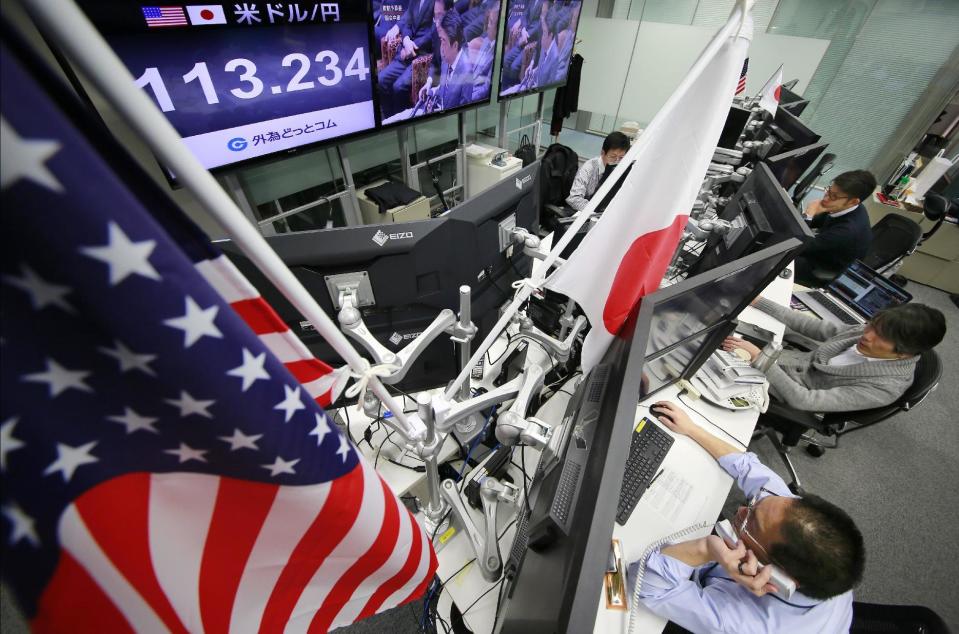 Money traders watch computer screens with the day's exchange rate between Japanese yen and the U.S. dollar at a foreign exchange brokerage in Tokyo, Wednesday, Feb. 1, 2017. Japanese officials have rejected U.S. President Donald Trump's suggestion that Tokyo is seeking to weaken the yen against the U.S. dollar to gain a trade advantage. (AP Photo/Shizuo Kambayashi)