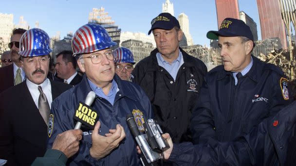 PHOTO: Vice President Dick Cheney, center, talks to reporters while on a tour of the World Trade Center site for the first time in New York, Oct. 18, 2001. (David Rentas/AP, FILE)