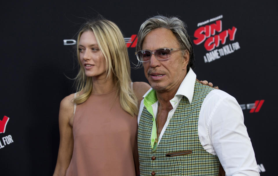 Cast member Mickey Rourke and Anastassija Makarenko (L) pose at the premiere of "Sin City: A Dame to Kill For" in Hollywood, California August 19, 2014. The movie opens in the U.S. on August 22. REUTERS/Mario Anzuoni (UNITED STATES - Tags: ENTERTAINMENT)