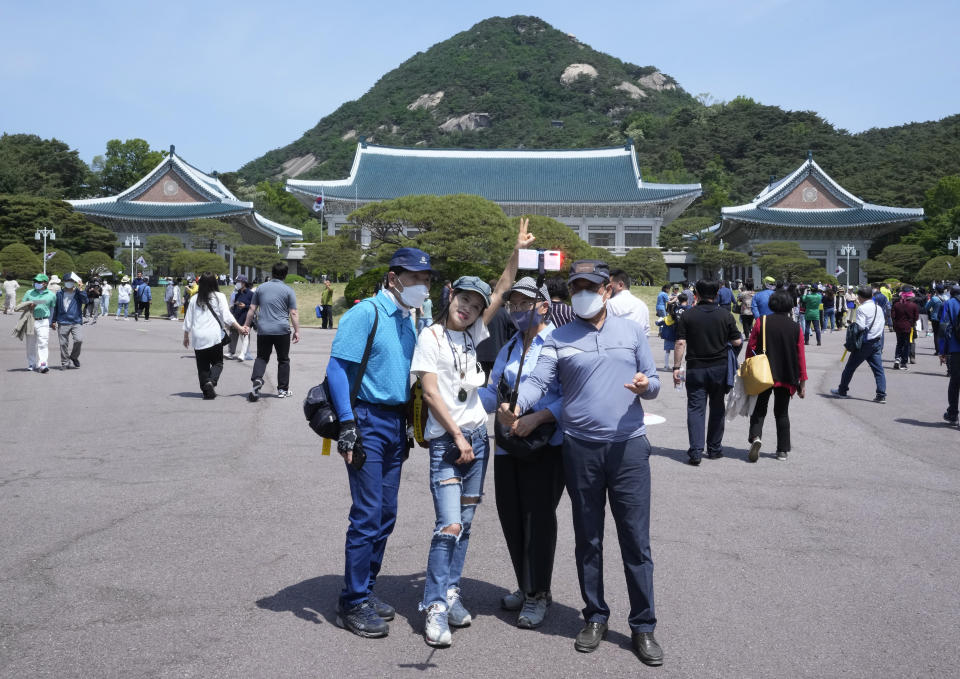 People take a selfie photo at the Blue House, the former presidential palace, in Seoul, South Korea, Thursday, May 12, 2022. For most South Koreans, the former presidential palace in Seoul was as shrouded in mystery as the buildings in their secretive rival North Korea. That’s now changed recently as thousands have been allowed a look inside for the first time in 74 years.(AP Photo/Ahn Young-joon)