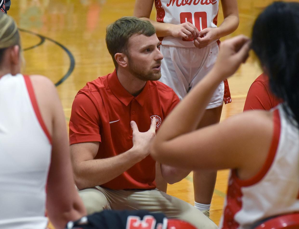 Trent Moody talks to Monroe's girls basketball team during a game against Erie Mason on Dec. 5. His Trojans beat Whiteford Wednesday to improve to 3-0.