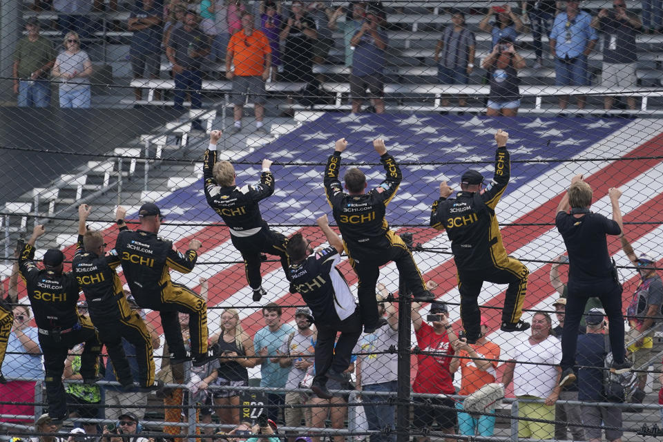 Tyler Reddick, fourth from left, celebrates with his team after winning a NASCAR Cup Series auto race at Indianapolis Motor Speedway, Sunday, July 31, 2022, in Indianapolis. (AP Photo/Darron Cummings)