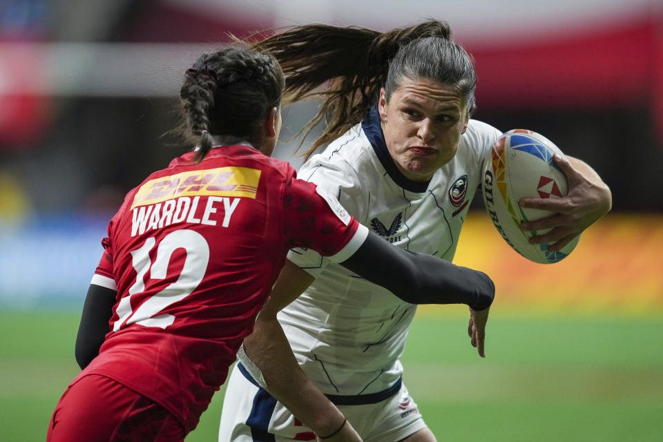 FILE - United States' Ilona Maher, right, runs the ball past Canada's Keyara Wardley during a Canada Sevens women's rugby match in Vancouver, British Columbia, Friday, March 3, 2023.The main task for Maher, the breakout social media star on TikTok at the Tokyo Olympics, is winning a medal in Paris. (Darryl Dyck/The Canadian Press via AP, File)