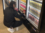 Ethan McKee, vice president of Mango Cannabis, arranges marijuana-infused soda inside a cooler at a medical dispensary, Tuesday, Feb. 28, 2023, in Oklahoma City. Voters in Oklahoma, which already has a robust medical marijuana program, will decide on Tuesday, March 7, whether to legalize cannabis for adults over the age of 21. (AP Photo by Sean Murphy)