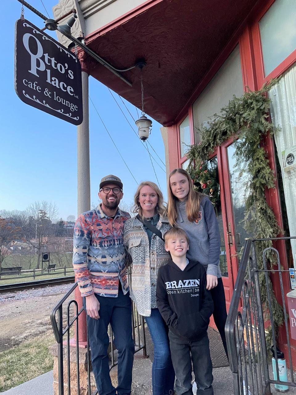 From left, Kevin Scharpf, Lyndsi Scharpf, Lola Scharpf, and Lloyd Scharpf stand in front of Otto's Place, the latest restaurant from the James Beard Foundation semifinalist.