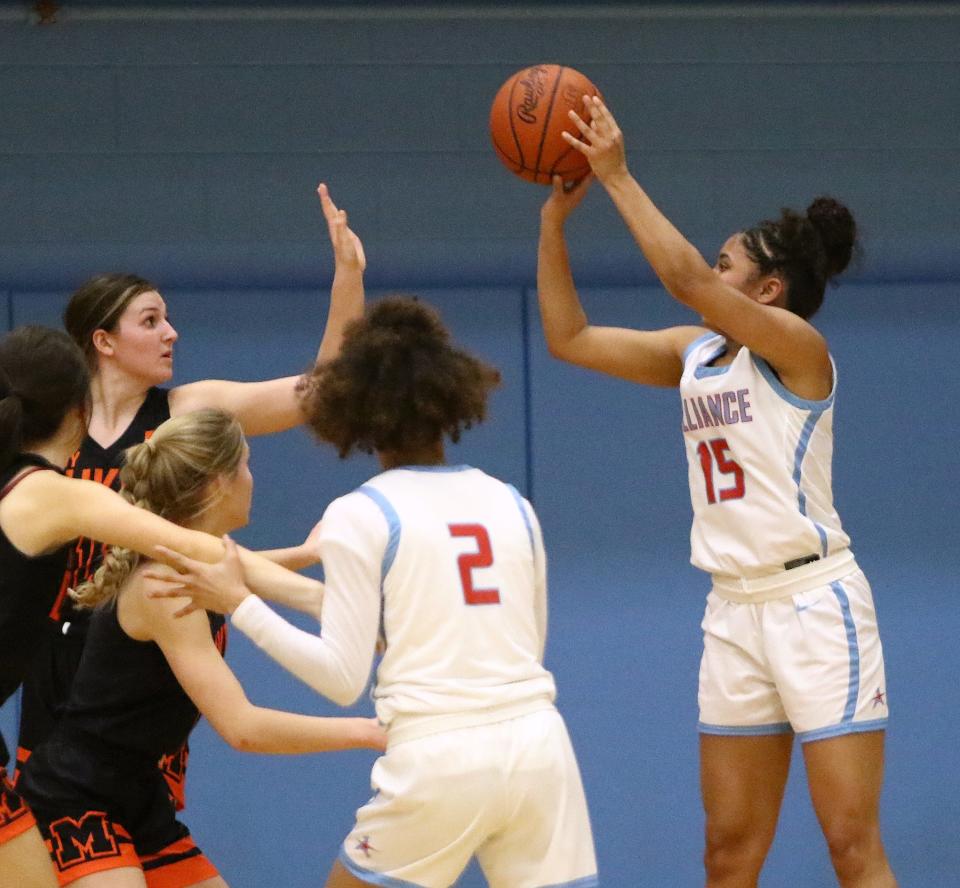 Alliance's Jayla Callock (15) puts up a shot over Marlington defenders during action at Alliance High School Wednesday night, February 1, 2023.