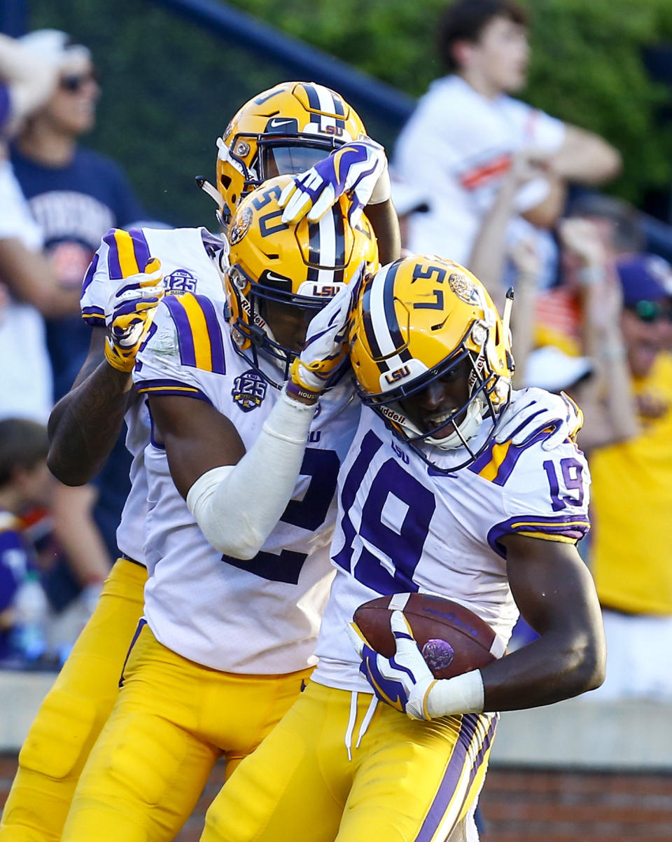 LSU wide receiver Derrick Dillon (19) celebrates with teammates after scoring a touchdown during the second half of an NCAA college football game against Auburn, Saturday, Sept. 15, 2018, in Auburn, Ala. (AP Photo/Butch Dill)
