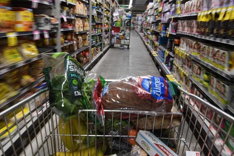 A shopping trolley is seen alongside available perishable goods in a supermarket in Sydney.