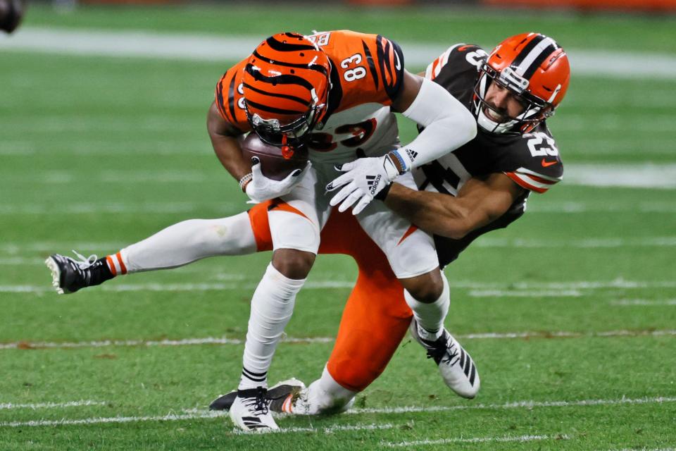 Cleveland Browns strong safety Andrew Sendejo (23) tackles Cincinnati Bengals wide receiver Tyler Boyd (83) on Sept. 17, 2020.