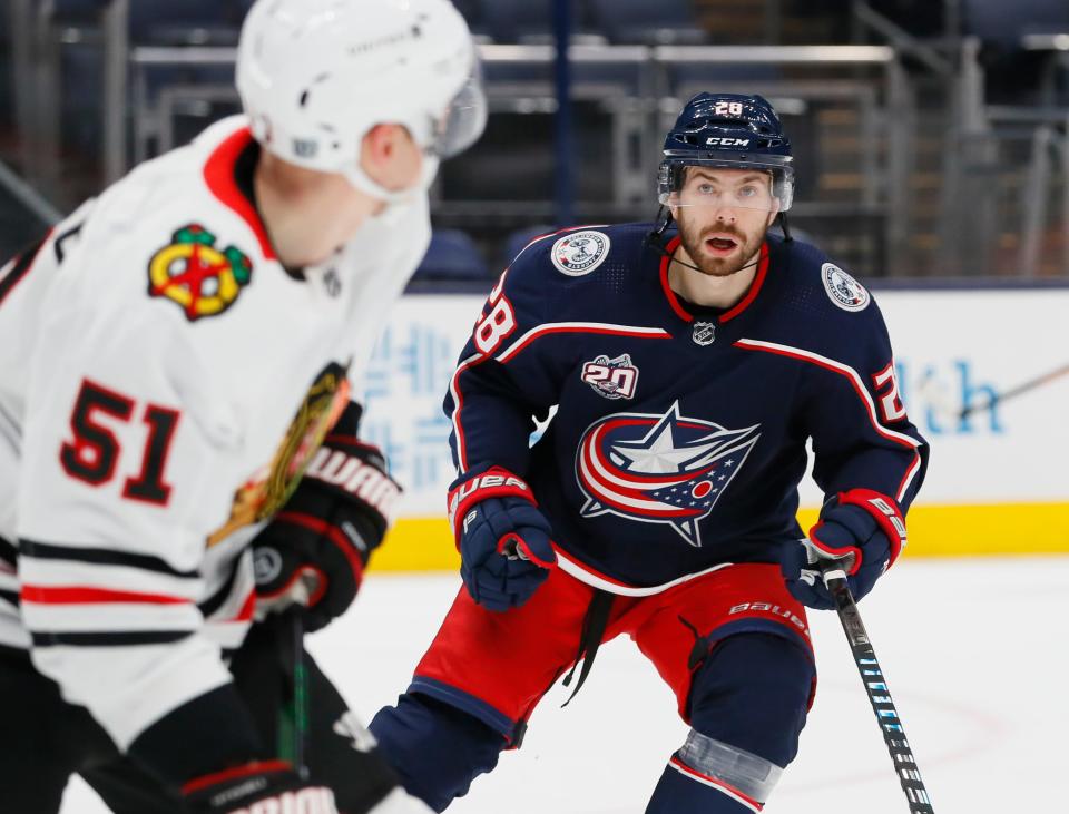 Columbus Blue Jackets right wing Oliver Bjorkstrand (28) eyes Chicago Blackhawks defenseman Ian Mitchell (51) during the first period of the NHL hockey game at Nationwide Arena in Columbus on Thursday, Feb. 25, 2021. The Blue Jackets lost 2-0.