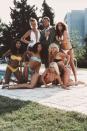 <p>Roger Moore as 007, surrounded by bikini-clad women in a publicity still for <em>For Your Eyes Only.</em></p>