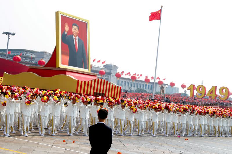 FILE PHOTO: Float carrying a portrait of Chinese President Xi Jinping moves through Tiananmen Square during the parade marking the 70th founding anniversary of People's Republic of China, on its National Day in Beijing