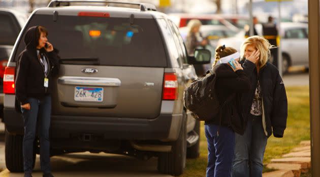 Students and faculty mingle outside of the police line on the Casper College campus as police investigate. Photo: AAP