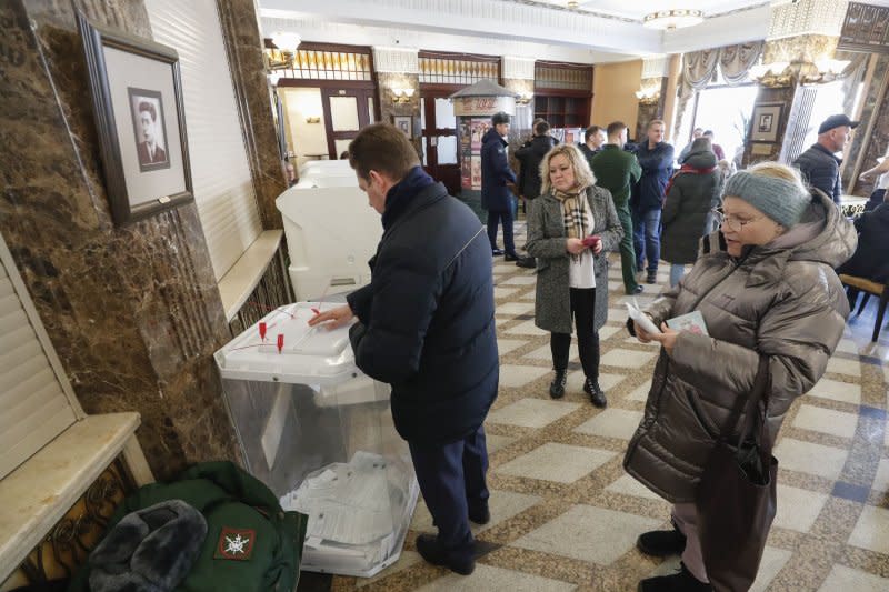 Russian voters at a polling station in Moscow on Friday cast their ballots in a presidential election Vladimir Putin is almost guaranteed to win despite rising poverty, creaking education and healthcare systems and crumbling infrastructure. Photo by Maxim Shipenkov/EPA-EFE/MAXIM