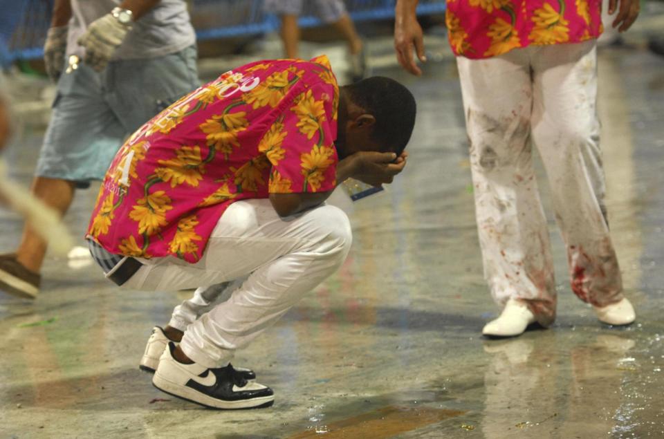 Horror: A member of the Paraiso de Tuiuti samba school moments after the crash (AP)