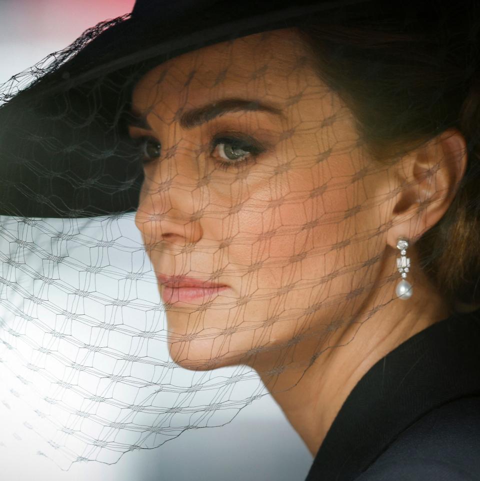 Britain's Catherine, Princess of Wales follows the coffin of Queen Elizabeth II, draped in the Royal Standard, and placed on the State Gun Carriage of the Royal Navy, as it travels from Westminster Abbey to Wellington Arch in London on September 19, 2022, after the State Funeral Service of Britain's Queen Elizabeth II. (Photo by Tom Jenkins / POOL / AFP) (Photo by TOM JENKINS/POOL/AFP via Getty Images)