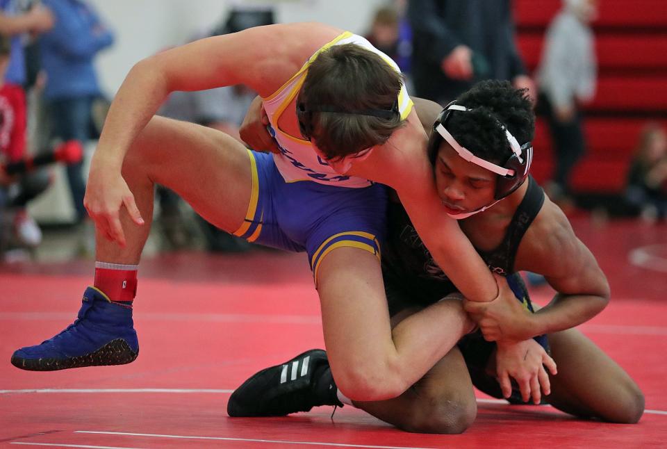 Nordonia's Israel Petite, right, wrestles Findlay's Ethan Mitchell during their 138 pound match in the quarterfinal round of the Grizzly Invitational wrestling tournament on Saturday.