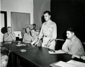 FILE - In this Aug. 7, 1945, file photo, Col. Paul W. Tibbets, standing, pilot of the B-29 Enola Gay which dropped the atomic bomb on Hiroshima, western Japan, describes the flight during a news conference at Strategic Air Force headquarters on Guam, one day after the atomic bombing. At 8:15 a.m., the U.S. B-29 bomber Enola Gay dropped the 4-ton “Little Boy” uranium bomb from a height of 9,600 meters (31,500 feet) on the city center, targeting the Aioi Bridge. (AP Photo/Max Desfor, File)