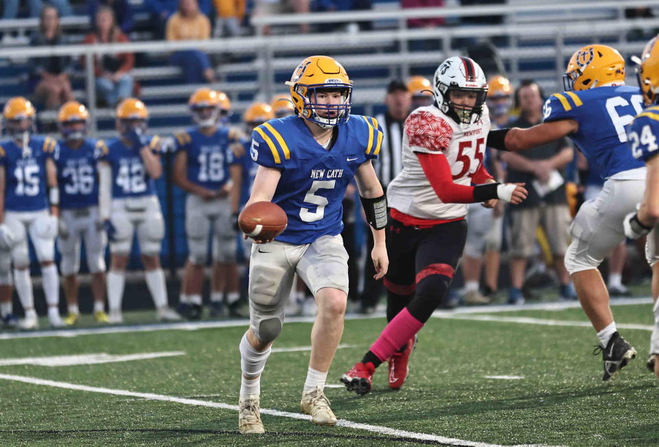 Newport Central Catholic quarterback Louie Collopy (5) pitches the ball during their 22-6 win over Newport Friday, Oct. 6, 2023.