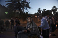 A Palestinian woman who lives in a house under threat of eviction moves prayer mats for outdoor prayers during the Muslim holy month of Ramadan, in the Sheikh Jarrah neighborhood of east Jerusalem, Friday, May 7, 2021. Dozens of Palestinian families in east Jerusalem are at risk of losing their homes to Jewish settler groups following a decades-long legal battle. The threatened evictions have sparked weeks of protests and clashes in recent days, adding to the tensions in Jerusalem. (AP Photo/Maya Alleruzzo)