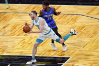 Charlotte Hornets forward Gordon Hayward, left, drives past Orlando Magic guard Terrence Ross (31) during the second half of an NBA basketball game, Sunday, Jan. 24, 2021, in Orlando, Fla. (AP Photo/John Raoux)