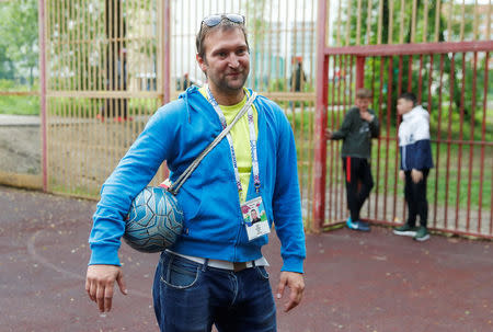 Soccer fan Pavel Cherkas, who was blacklisted by Russian authorities for bad behaviour at a stadium, poses for a picture with his 2018 World Cup fan ID, which was granted to Cherkas and later revoked, during an interview outside Moscow, Russia May 20, 2018. REUTERS/Maxim Shemetov