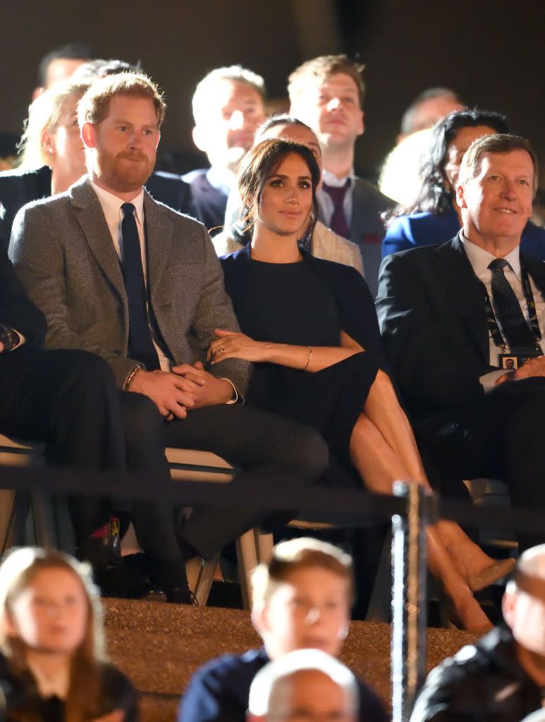 Meghan grabs a hold of Harry at the Opening Ceremony of the Invictus Games