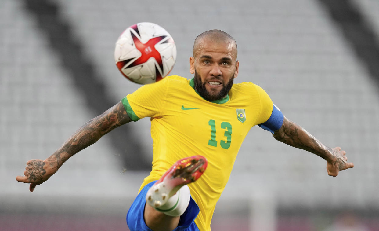 Brazil's Dani Alves kicks the ball during a men's soccer semifinal match at the 2020 Summer Olympics, Tuesday, Aug. 3, 2021, in Kashima, Japan. (Andre Penner/AP)