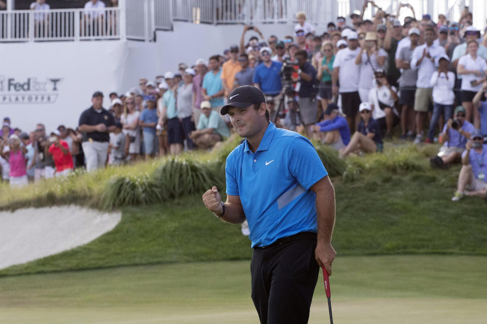 Patrick Reed pumps his fist on the 18th hole as he wins on the Northern Trust golf tournament at Liberty National Golf Course, Sunday, Aug. 11, 2019, in Jersey City, N.J. (AP Photo/Mark Lennihan)