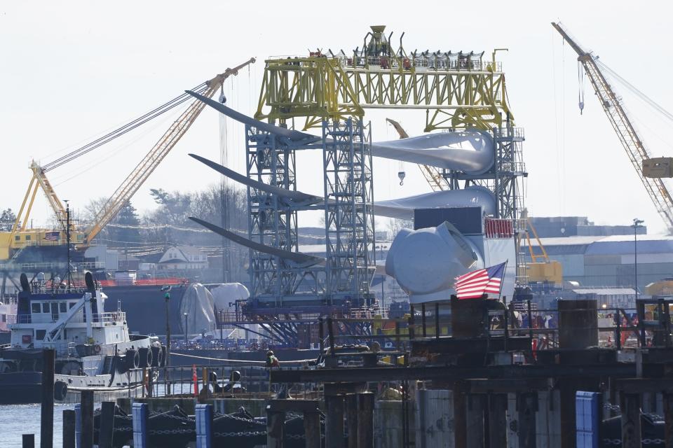 A generator and its blades are tugged out to sea from State Pier in New London, Conn., Monday, Dec. 4, 2023, to head to South Fork Wind farm. (AP Photo/Seth Wenig)