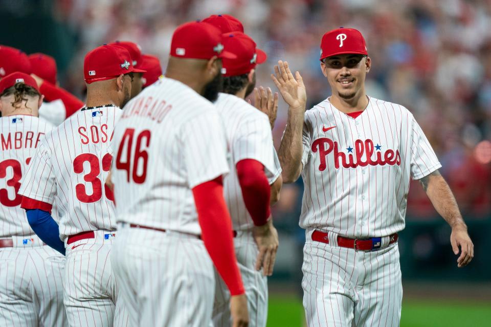 Philadelphia Phillies relief pitcher Orion Kerkering, right comes out for player introduction during the Game 1 in an NL wild-card baseball playoff series against the Miami Marlins, Tuesday, Oct. 3, 2023, in Philadelphia. The Phillies won 4-1, (AP Photo/Chris Szagola)