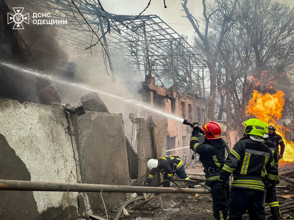 Firefighters work at the site of the Russian missile strike (via REUTERS)