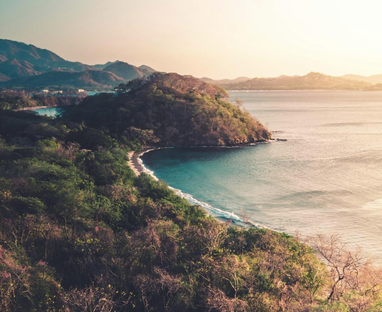 Costa Rica is a safe destination with plenty to offer travelers. Learn more about the extraordinary destination. pictured: an aerial view of the lush lands of Costa Rica during sunset