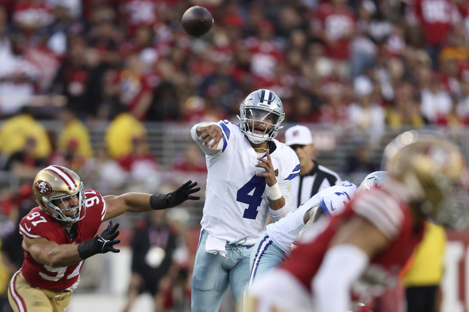 Dallas Cowboys quarterback Dak Prescott (4) passes as San Francisco 49ers defensive end Nick Bosa (97) applies pressure during the first half of an NFL football game in Santa Clara, Calif., Sunday, Oct. 8, 2023. (AP Photo/Jed Jacobsohn)