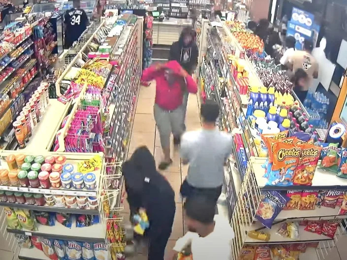 A still image from surveillance footage showing hordes people ransacking and vandalizing a 7-Eleven in California on August 15.