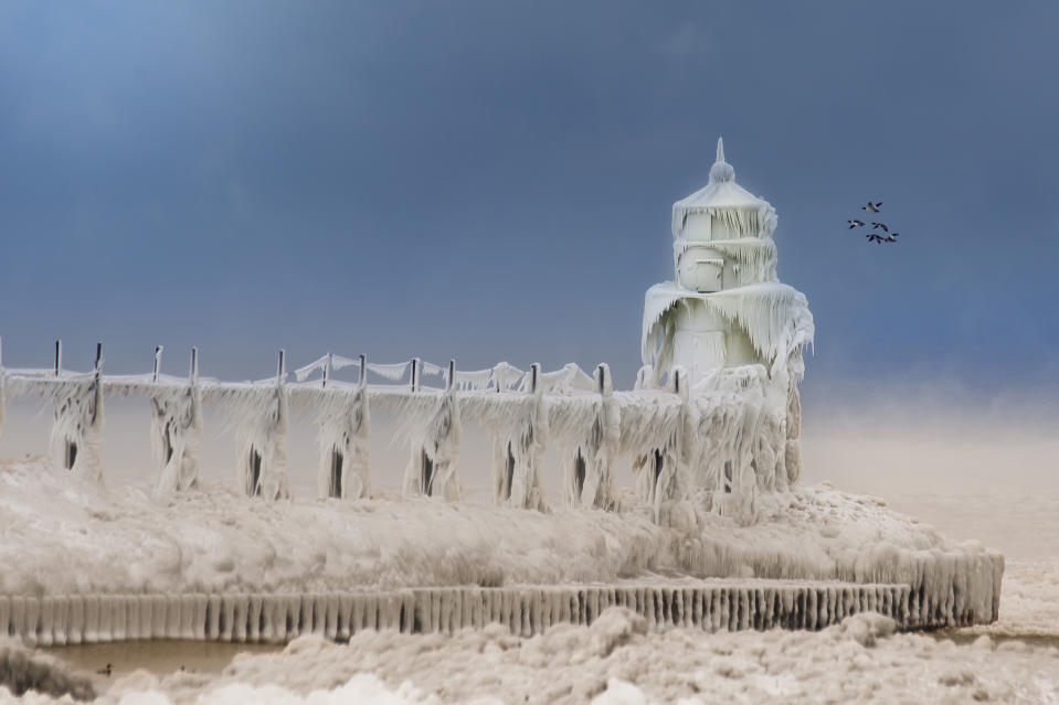 SOUTH HAVEN, MI - JANUARY 8: The front light at St Joseph, on January 8, 2015, in South Haven, Michigan.ICE engulfs a red lighthouse as a fierce winter storm grips South Haven, Michigan. Sharp icicles and surreal formations can be seen hanging from the railings after strong waves crashed onto the piers. After each coating the water quickly freezes to ice and the pier is transformed into a slippery, white wonderland. Weather in the area dipped into the minus figures and froze over Lake Michigan in the beginning of January.PHOTOGRAPH BY Mike Kline / Barcroft MediaUK Office, London.T +44 845 370 2233W www.barcroftmedia.comUSA Office, New York City.T +1 212 796 2458W www.barcroftusa.comIndian Office, Delhi.T +91 11 4053 2429W www.barcroftindia.com