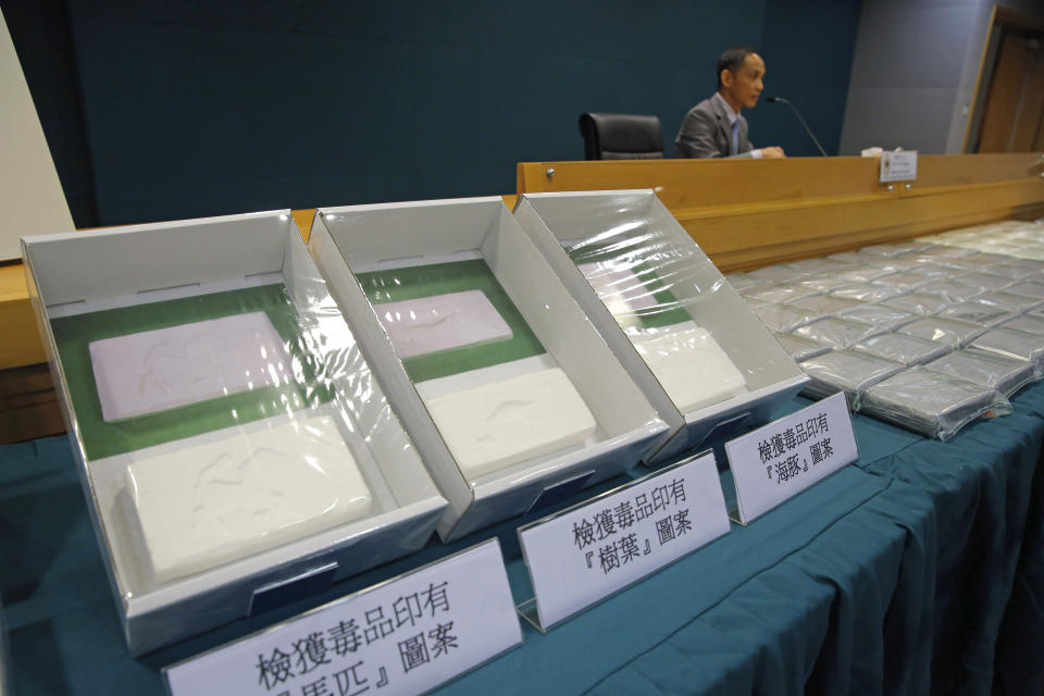 Head of Customs Drug Investigation Bureau Hui Wai-ming speaks as seized packages of cocaine are displayed during a news conference in Hong Kong, Thursday, April 4, 2019. A haul of cocaine with an estimated market value of $13 million has been seized in Hong Kong, customs agents said Thursday.(AP Photo/Kin Cheung)