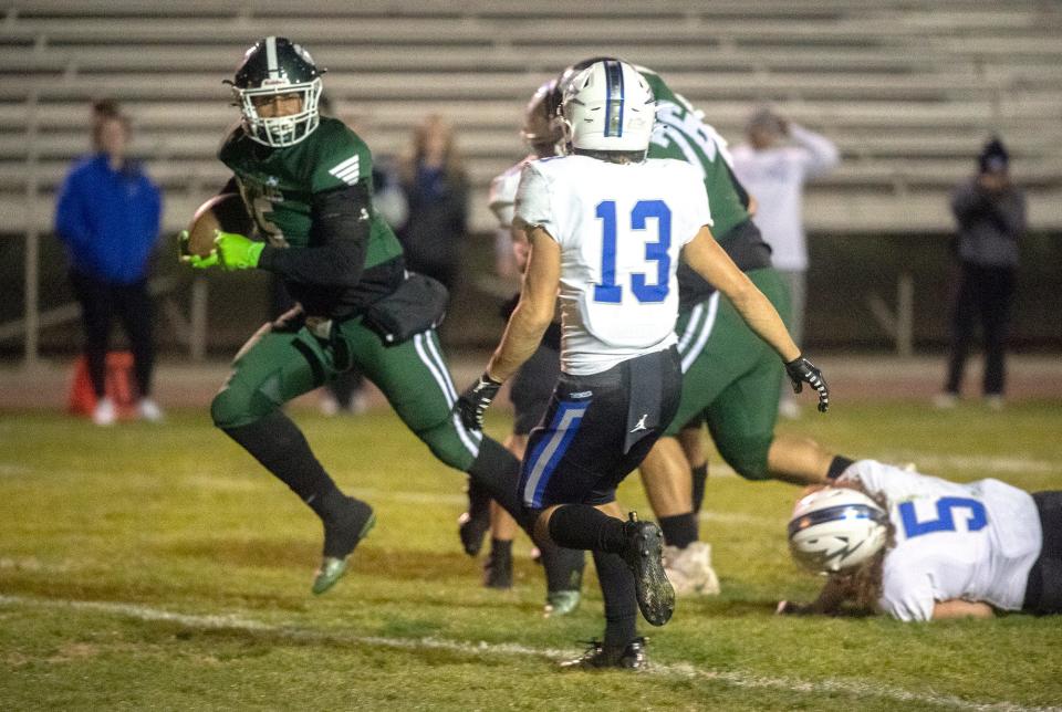 Manteca's Alijah Cota, left, makes his way into the end zone for a touchdown during a Sac-Joaquin Section Division II playoff game against Rocklin at Manteca's Guss Schmiedt Stadium.