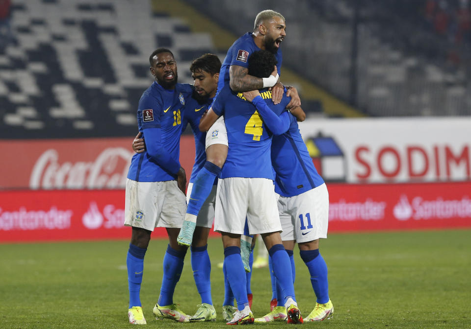 Brazil's Everton Ribeiro, right, is congratulated by teammates after scoring his side's opening goal against Chile during a qualifying soccer match for the FIFA World Cup Qatar 2022 at Monumental Stadium in Santiago, Chile, Thursday, Sept. 2, 2021. (Claudio Reyes/Pool via AP)