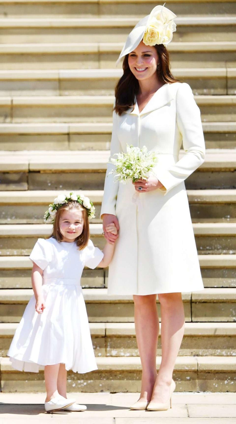 TOPSHOT - Princess Charlotte and Britain's Catherine, Duchess of Cambridge leave the wedding ceremony of Britain's Prince Harry, Duke of Sussex and US actress Meghan Markle at St George's Chapel, Windsor Castle, in Windsor, on May 19, 2018. (Photo by Ben STANSALL / POOL / AFP) (Photo credit should read BEN STANSALL/AFP via Getty Images)