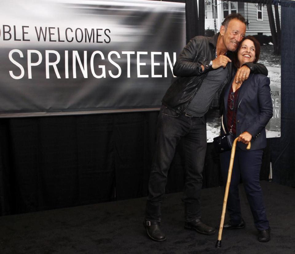 FILE - In this Sept. 27, 2016, file photo, Bruce Springsteen greets a fan at the launch of his autobiography "Born to Run" at the Barnes & Noble in the New Jersey town where he grew up, in Freehold, N.J. While it takes Springsteen close to four hours to effectively revisit the four-plus decades of his career in concert, the Boss needed just 90 minutes to chronicle his life story at New Jersey's Monmouth University. The 67-year-old Garden State-born rocker spoke at the school in West Long Branch Tuesday night, Jan. 10, 2017, as part of an "intimate conversation" moderated by Grammy Museum Executive Director Bob Santelli. (AP Photo/Mel Evans)