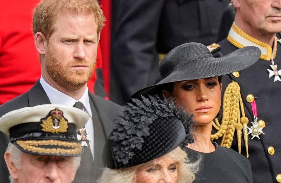 Mandatory Credit: Photo by Martin Meissner/AP/Shutterstock (13401795ar) Britain's King Charles III, from bottom left, Camilla, the Queen Consort, Prince Harry and Meghan, Duchess of Sussex watch as the coffin of Queen Elizabeth II is placed into the hearse following the state funeral service in Westminster Abbey in central London . The Queen, who died aged 96 on Sept. 8, will be buried at Windsor alongside her late husband, Prince Philip, who died last year Royals Funeral, London, United Kingdom - 19 Sep 2022