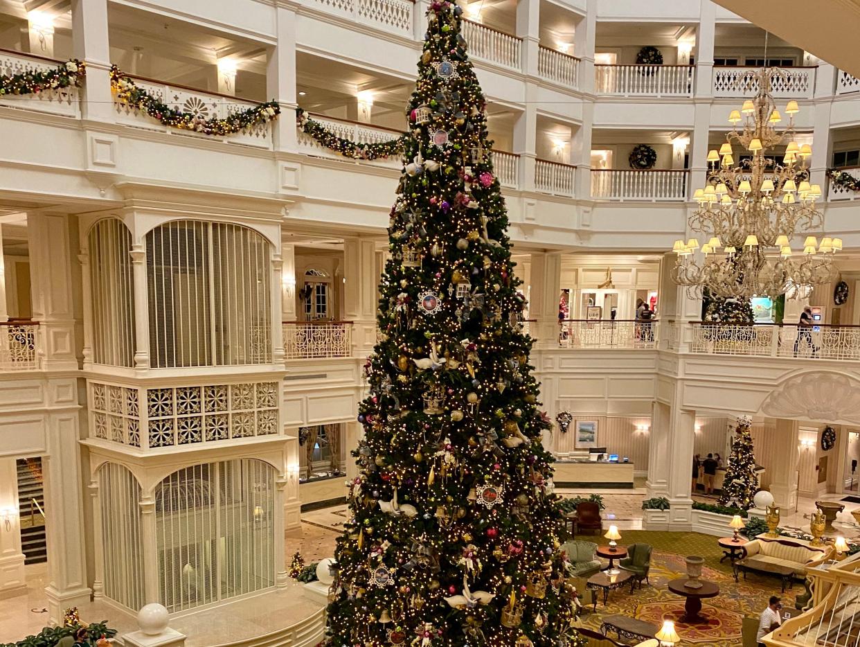 lobby of grand flordian resort decorated for christmas with a big tree