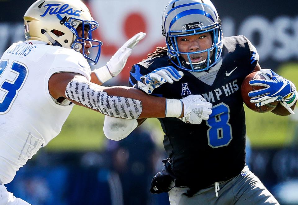 Memphis running back Darrell Henderson (right) fights for positive yards against  Tulsa defender Zaven Collins (left) during action in Memphis, Tenn., Saturday, November 10, 2018.