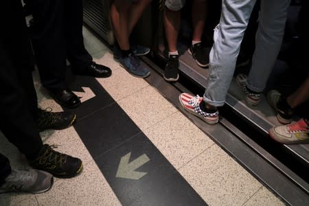 Anti-extradition bill demonstrators block a Mass Transit Railway (MTR) train in Hong Kong